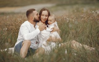 Happy family enjoying quality time in a serene meadow setting.