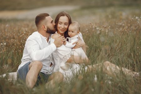 Happy family enjoying quality time in a serene meadow setting.